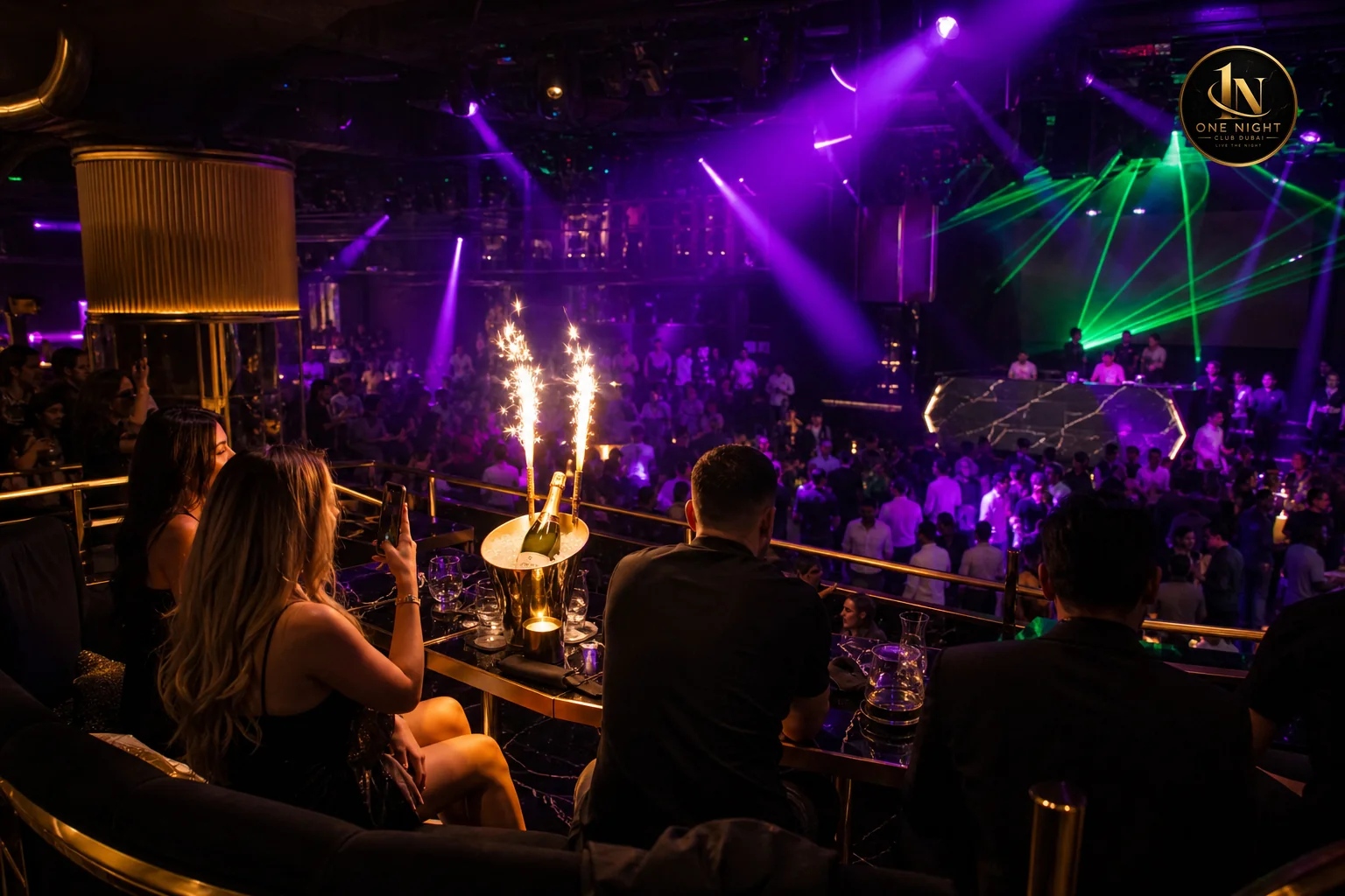 Indoor nightclub table with immersive lighting and stage energy contrasted with view-focused rooftop setup. Photorealistic photo of a modern indoor Dubai nightclub VIP table area with dramatic purple and green stage lighting (#8A2BE2 and