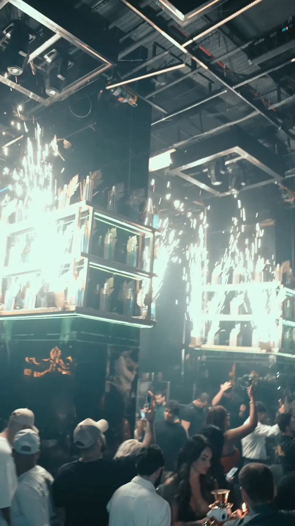 The lit bottle display behind the bar